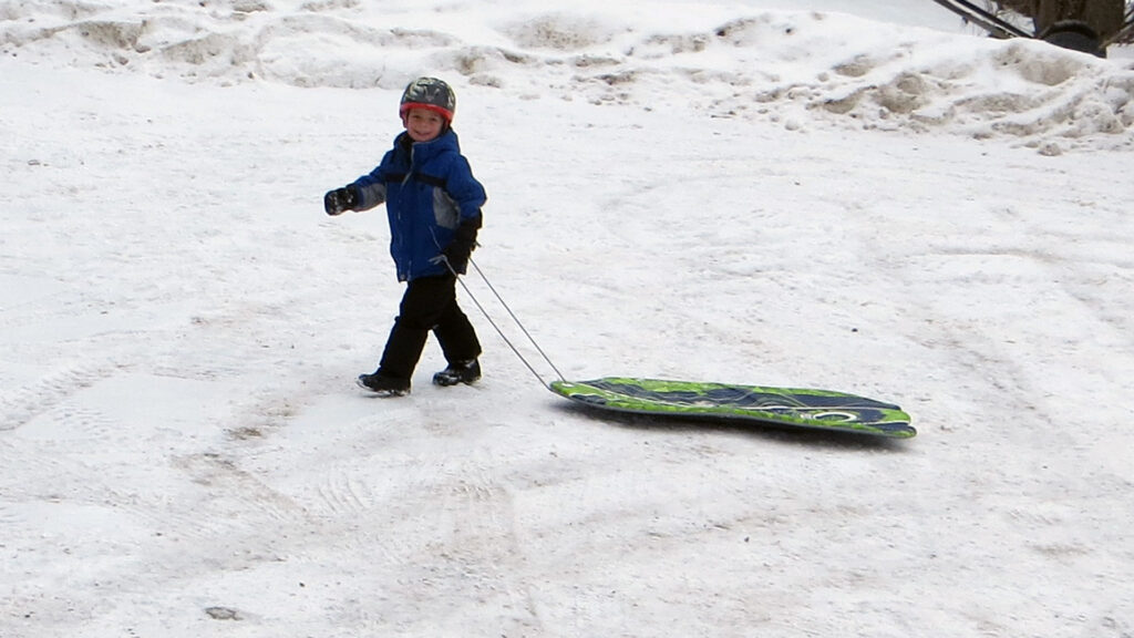 Young Kid with Green Sled